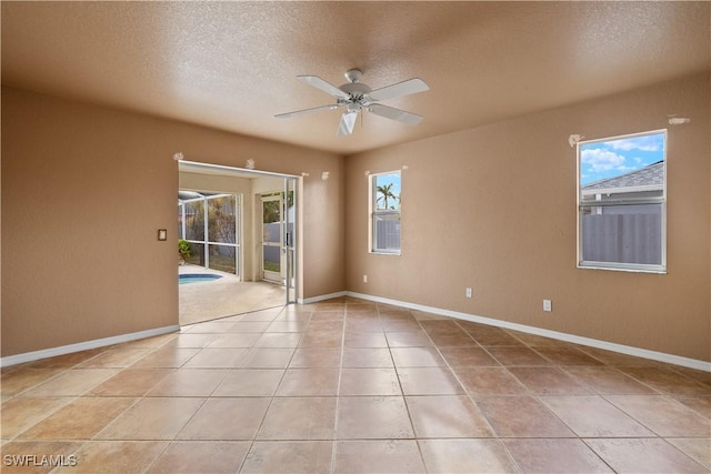 unfurnished room featuring light tile patterned floors, a textured ceiling, and ceiling fan