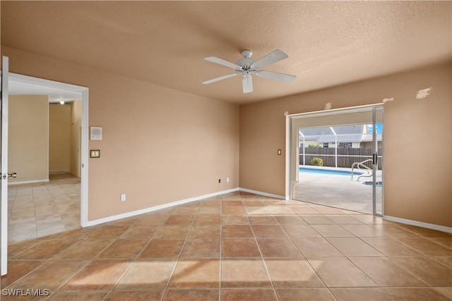 unfurnished room with ceiling fan, a textured ceiling, and light tile patterned floors