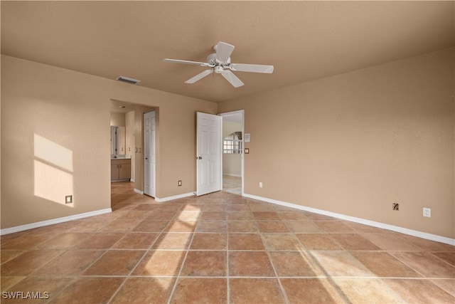 tiled empty room with ceiling fan