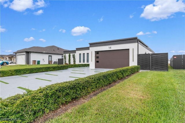 view of front of property featuring a front lawn and a garage