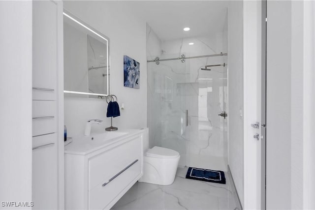 bathroom featuring vanity, toilet, and an enclosed shower