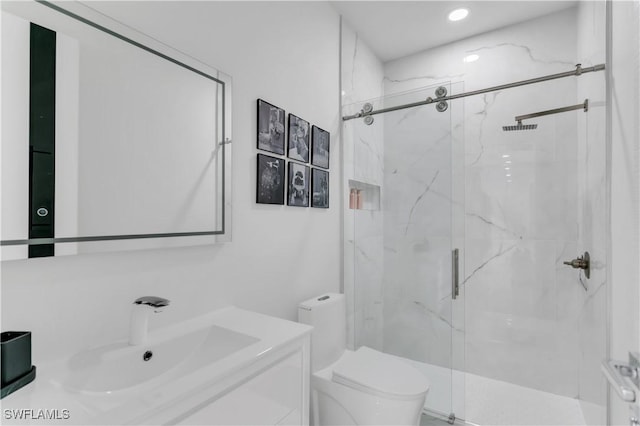 bathroom featuring vanity, toilet, and an enclosed shower