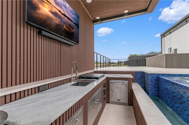 view of patio with exterior kitchen and sink