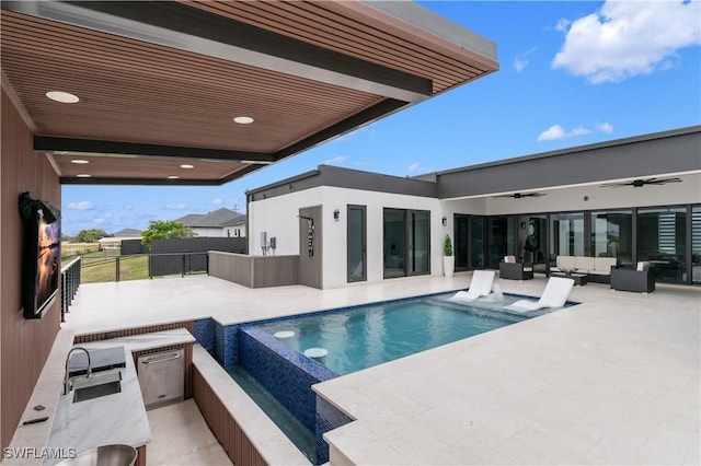 view of pool featuring ceiling fan, sink, a patio area, an outdoor hangout area, and area for grilling