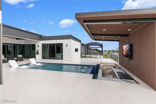 view of swimming pool with a patio and ceiling fan