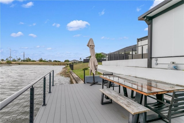 wooden terrace featuring a water view