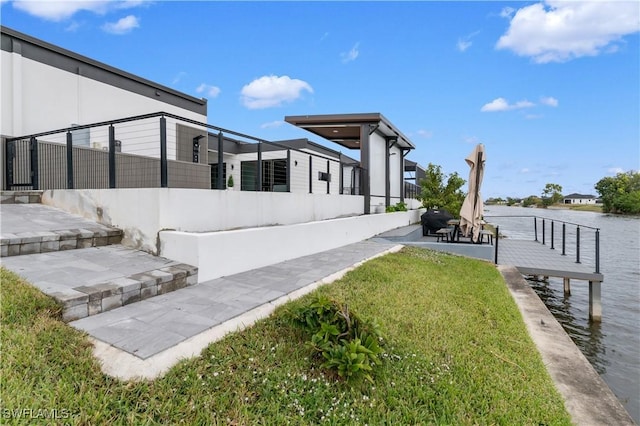 view of yard with a patio area and a water view