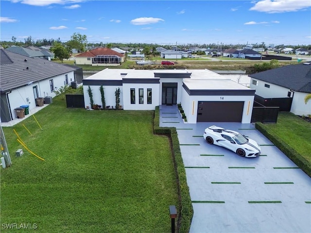 modern home featuring a front lawn, cooling unit, a garage, and french doors