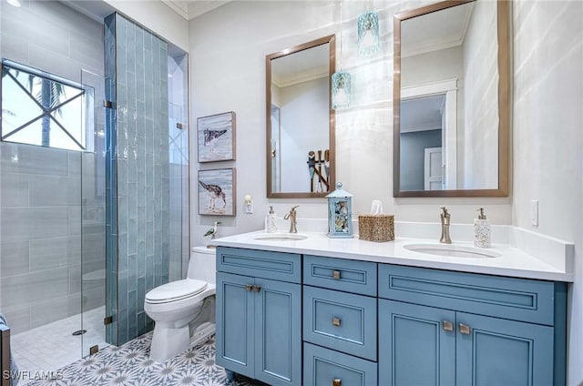 bathroom with crown molding, vanity, a shower with shower door, and toilet