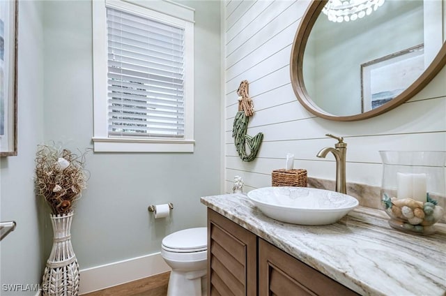 bathroom with hardwood / wood-style floors, vanity, and toilet