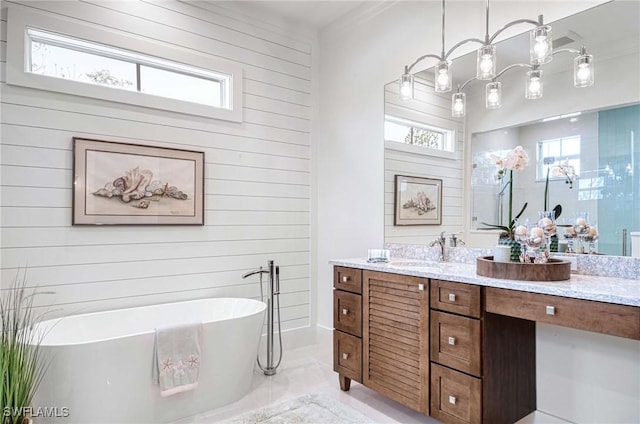 bathroom with a bathing tub, vanity, and wooden walls