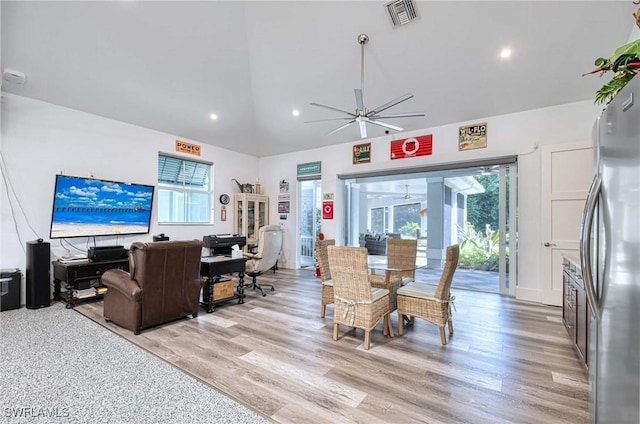 dining area with vaulted ceiling, light hardwood / wood-style flooring, and ceiling fan