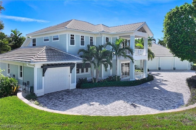 view of front of home with a garage and a balcony