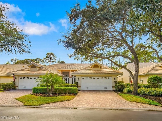 mediterranean / spanish-style home featuring a garage