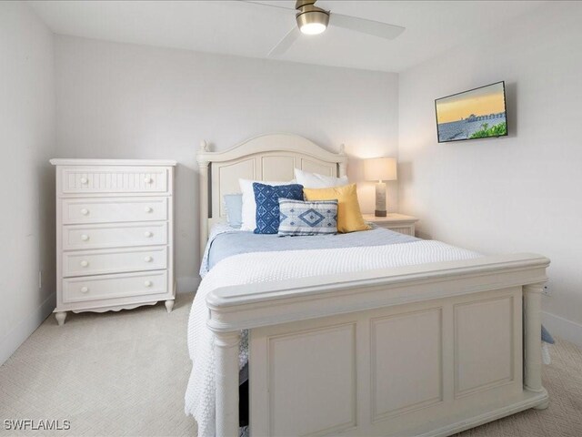 bedroom with ceiling fan and light colored carpet