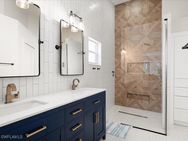 bathroom with tile patterned flooring, vanity, and tile walls