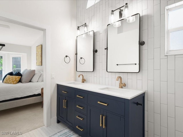 bathroom featuring tile patterned flooring, vanity, and tasteful backsplash