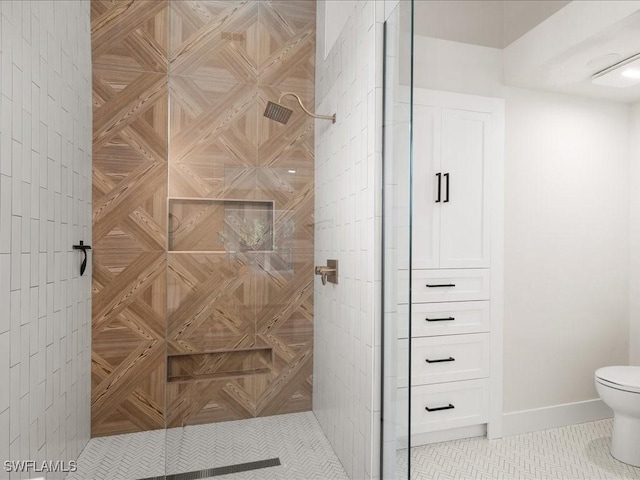 bathroom featuring tile patterned flooring, toilet, and walk in shower