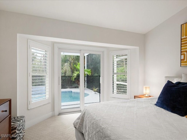 carpeted bedroom featuring access to outside and multiple windows