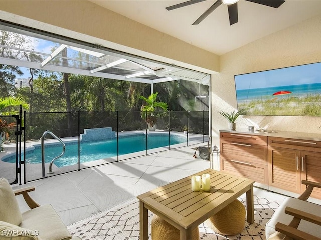 view of swimming pool with glass enclosure and a patio