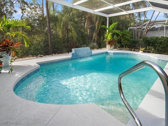 view of swimming pool featuring glass enclosure and pool water feature