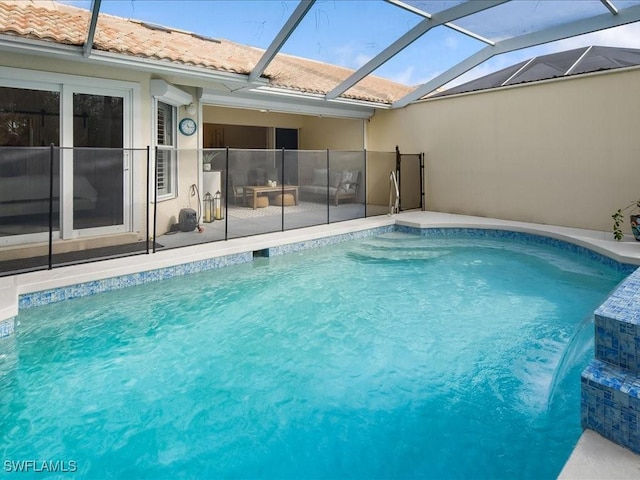 view of swimming pool featuring pool water feature and glass enclosure