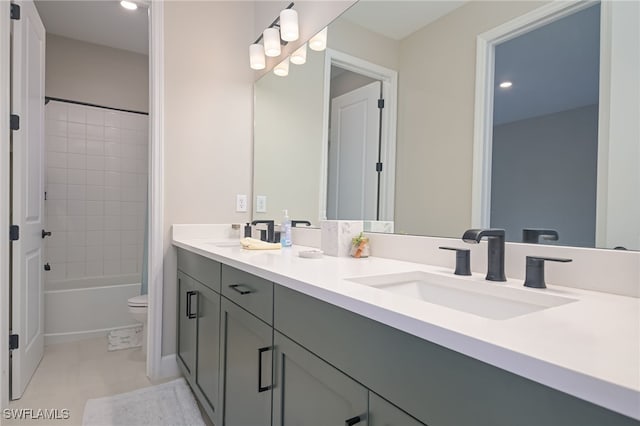 full bathroom featuring vanity, toilet, and tiled shower / bath