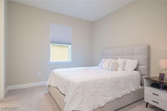 bedroom featuring light colored carpet