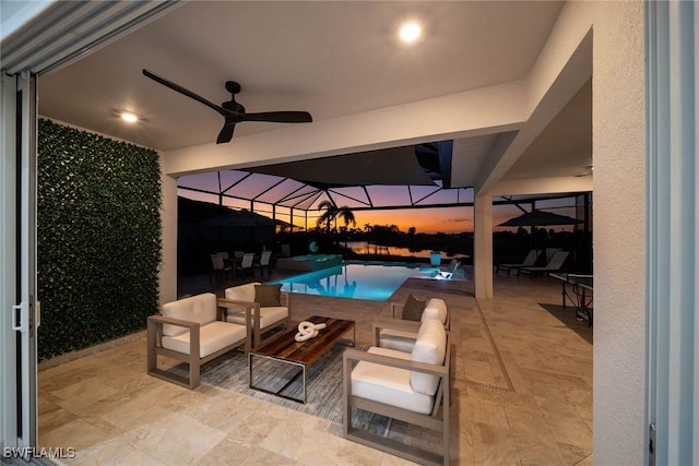 view of patio featuring ceiling fan, a lanai, and an outdoor living space