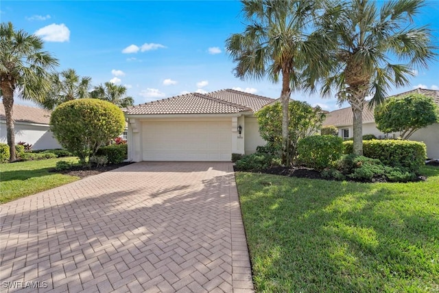 view of front of home featuring a garage and a front lawn