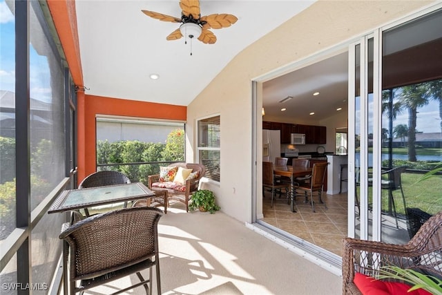 sunroom featuring ceiling fan and vaulted ceiling