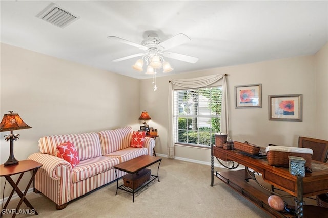 carpeted living room with ceiling fan