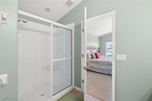 bathroom with a shower with shower door and vaulted ceiling