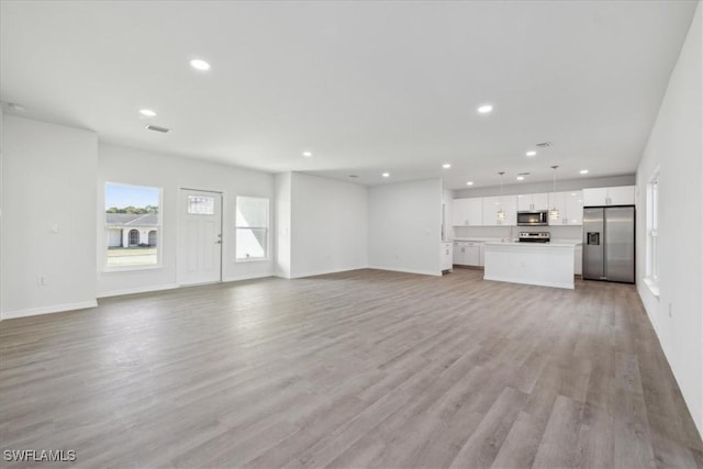 unfurnished living room featuring light wood-type flooring