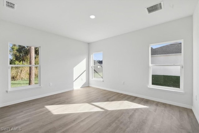 unfurnished room with hardwood / wood-style flooring