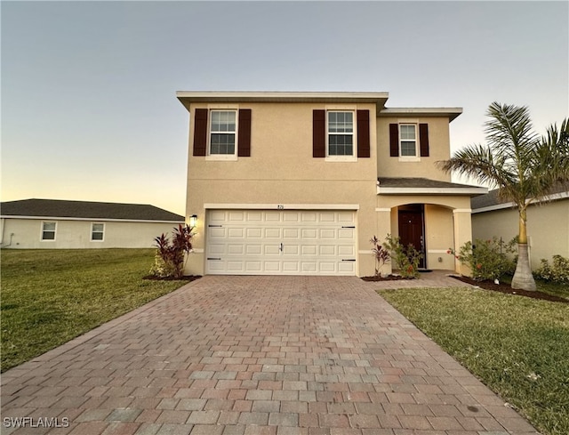 view of front facade with a lawn and a garage