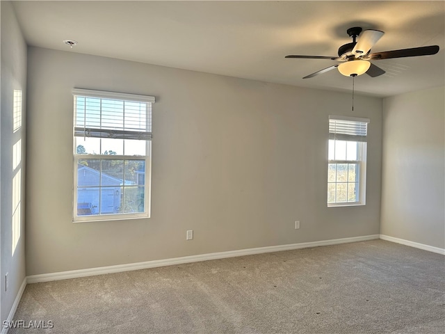 spare room with carpet flooring and ceiling fan