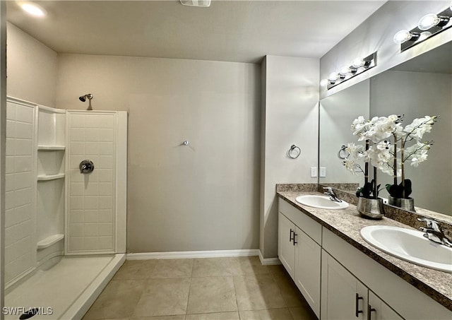 bathroom featuring vanity, tile patterned floors, and walk in shower