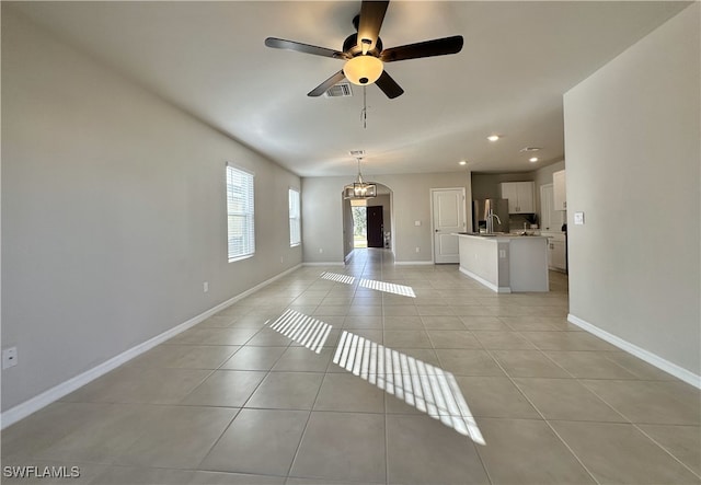 unfurnished living room with ceiling fan and light tile patterned floors