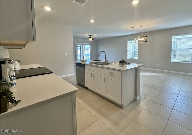 kitchen with a kitchen island with sink, ceiling fan, a healthy amount of sunlight, and stainless steel dishwasher