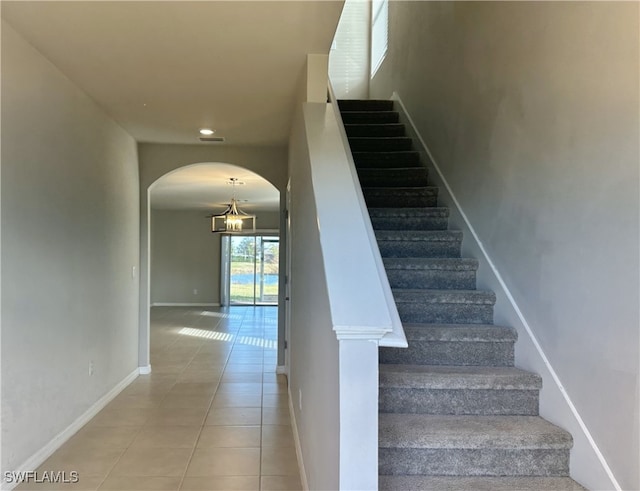 staircase featuring tile patterned flooring