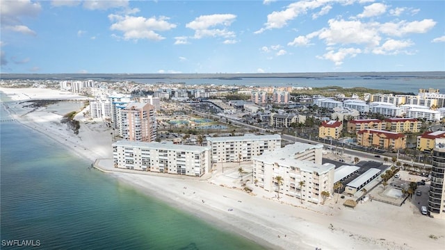 birds eye view of property featuring a water view and a beach view