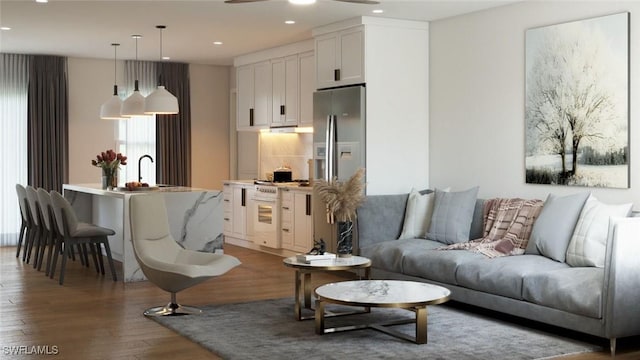 living room featuring ceiling fan and dark hardwood / wood-style flooring