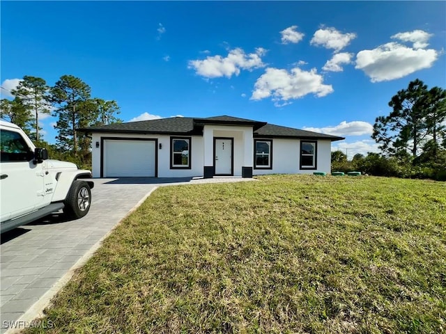 view of front of home featuring a garage and a front lawn