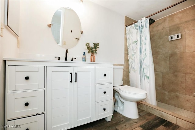 bathroom featuring vanity, hardwood / wood-style flooring, toilet, and a shower with shower curtain