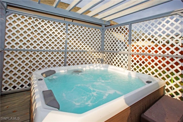 wooden deck with a hot tub