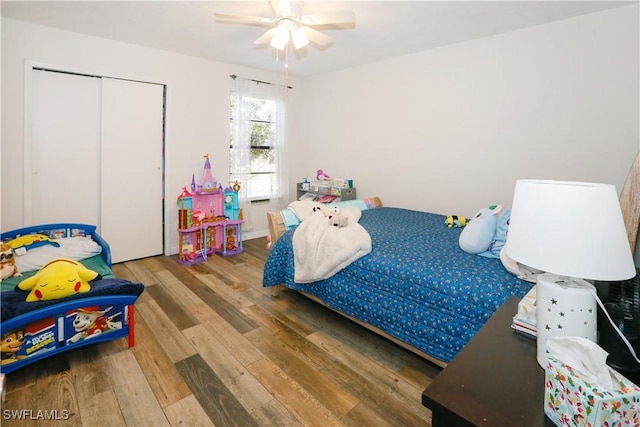 bedroom with wood-type flooring, a closet, and ceiling fan