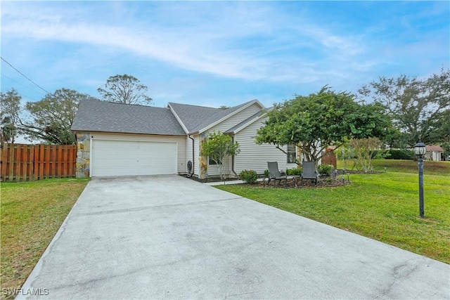 ranch-style house featuring a garage and a front yard