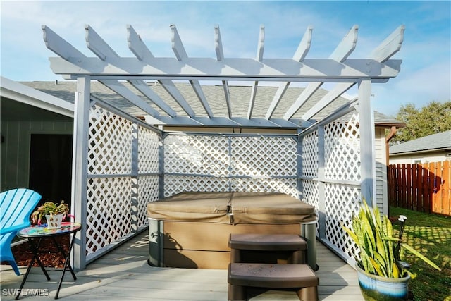 view of patio / terrace with a wooden deck, a hot tub, and a pergola