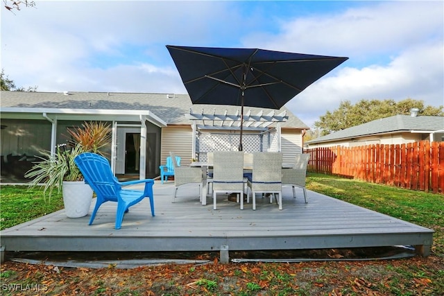 wooden terrace featuring a pergola and a lawn